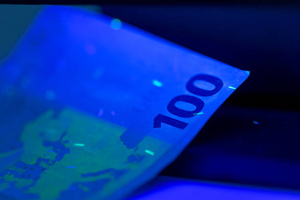 istock Close-up view of a 100 Euro banknote under ultraviolet light showcasing its security features 2250760843