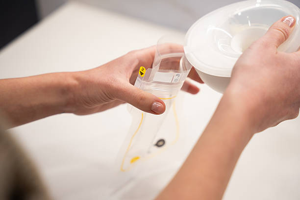 istock Hands filling a transparent breast milk storage bag 2250761101