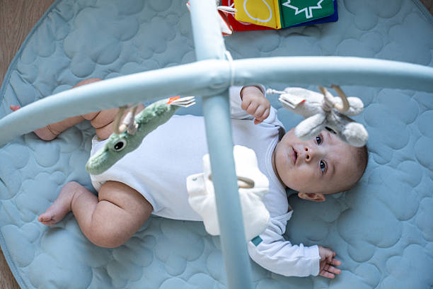 istock Baby lying on playmat under activity gym 2250761184