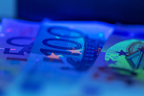 istock Colorful euro banknotes stacked on a surface under blue lighting 2250761195