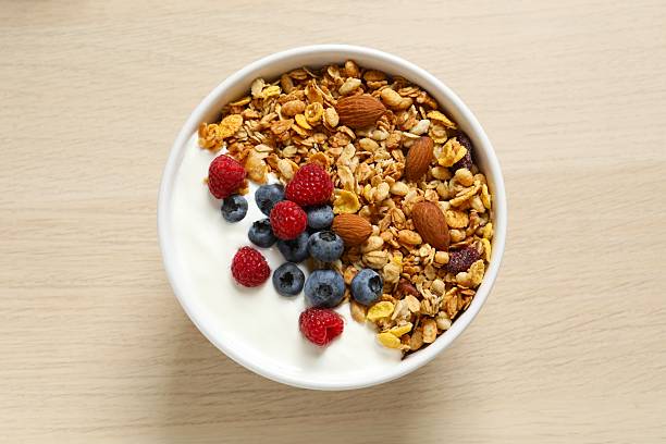 istock Delicious granola with berries and yogurt on a light background 2250762367