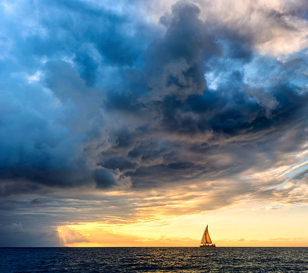 istock Sunset Inspirational Dramatic Approaching Storm Clouds Sailing Sailboat Ocean Hope Journey Adventure 2250762953