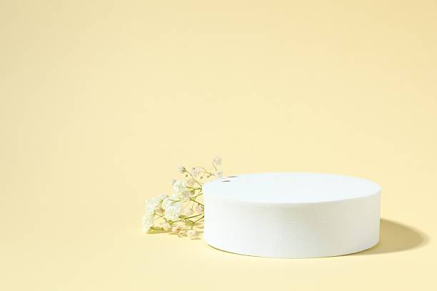 istock Podium and white gypsophila flowers on a colored background 2250764237