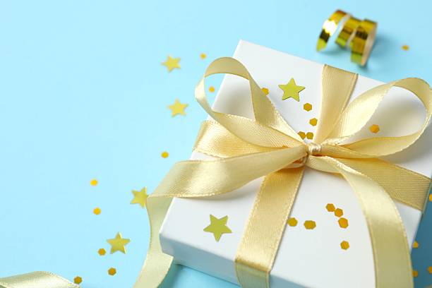 istock Beautiful gift box tied with bow on color background 2250764377