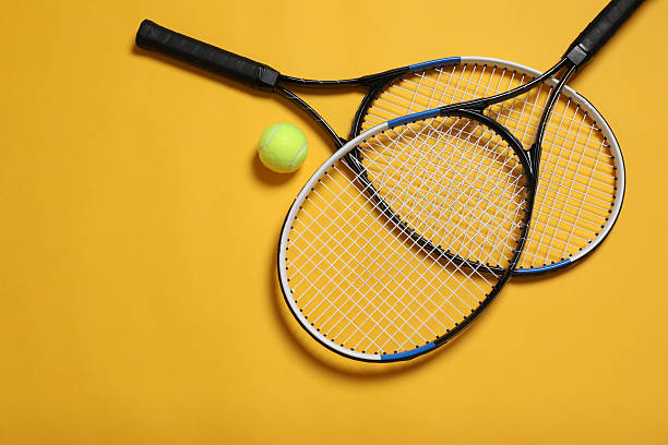 istock Tennis rackets and ball on color background 2250764516