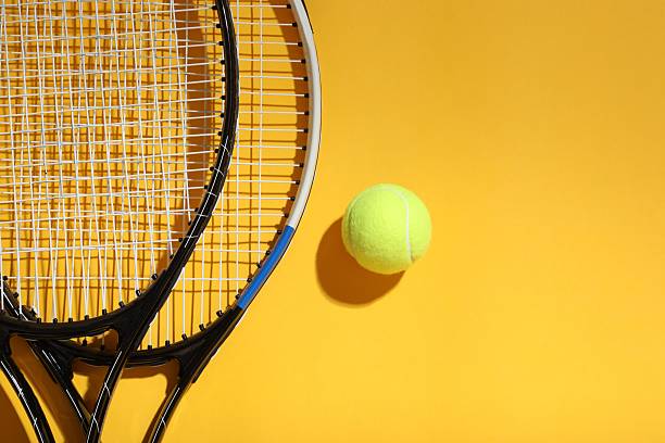 istock Tennis rackets and ball on color background 2250764517