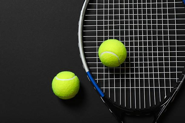 istock Tennis racket and balls on black background 2250764673