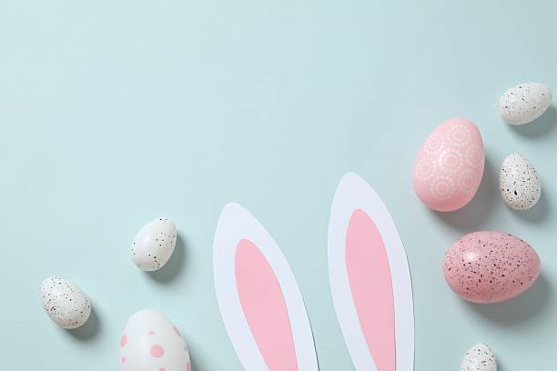 istock Happy Easter. Colorful eggs and bunny ears on color background, space for text or advertising 2250765181