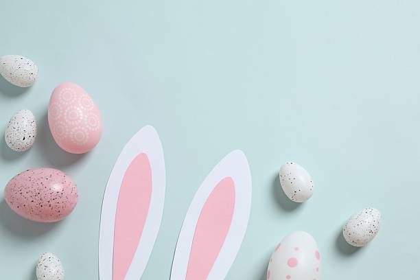 istock Happy Easter. Colorful eggs and bunny ears on color background, space for text or advertising 2250765182
