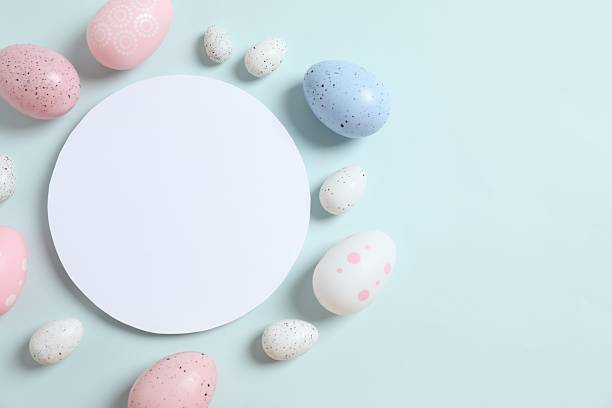 istock Happy Easter. Colorful eggs with white paper card on color background, space for text or advertising 2250765205