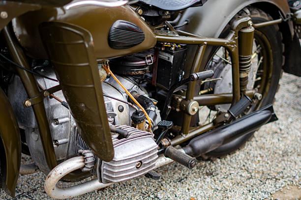 istock Dniepr motorcycle engine with boxer cylinder, components and exhaust system photographed from the side on gravel surface 2250765584