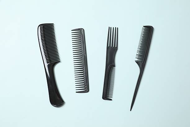 istock Professional combs and hairdresser tools on color background, top view 2250765615