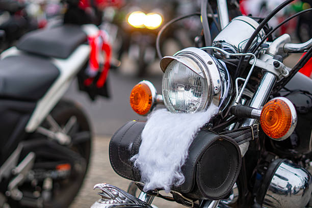 Motorcycle decorated with Santa’s white beard on the headlight and side bags during a festive Christmas motorcycle parade in town