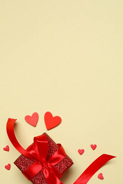 Gift box with red hearts on color background