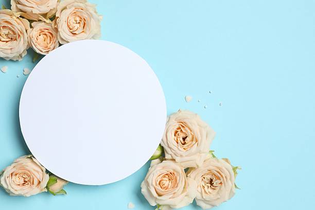 istock Beautiful pink peony roses with white paper card on a colored background 2250767586