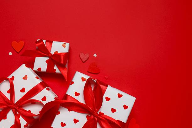 istock Gift boxes with red hearts on color background 2250767641