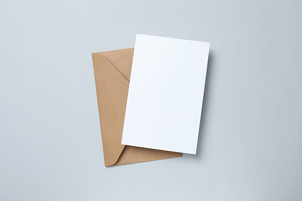 istock Paper envelope with paper card on grey background 2250768130