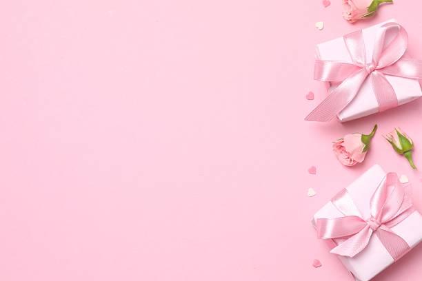 istock Beautiful composition with peony roses and gift boxes on color background 2250768543