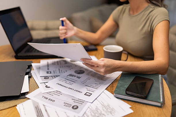 istock Modern woman reviewing important documents, writing the notes and preparing for a online presentation. 2250771157
