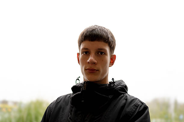 istock Young man with bowl cut wearing black jacket outdoors 2250771886