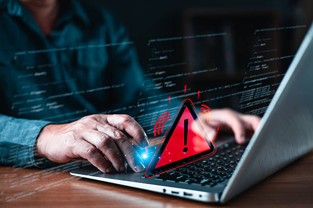 istock Cyber security alert and danger concept, hand typing on laptop with red warning triangle icon. Digital data breach, virus protection, system error, online threat, technology risk. 2250776550