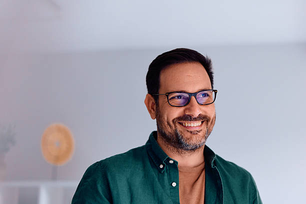 istock Smiling man wearing glasses looking away 2250776951