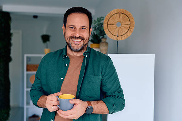 istock Happy man holding coffee mug at home 2250778027