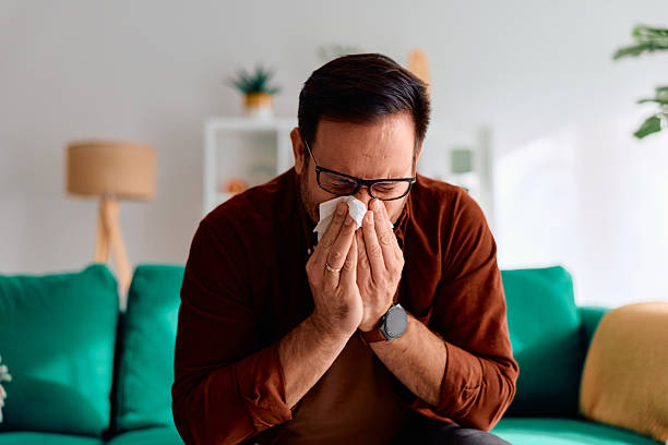 istock Man blowing nose with tissue having cold or allergy 2250778261