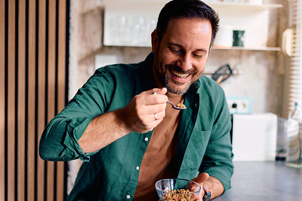 istock Happy man enjoying healthy breakfast cereal in kitchen 2250778277