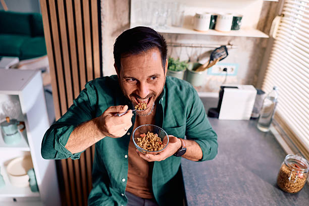 istock Man enjoying healthy breakfast cereal in kitchen 2250778279