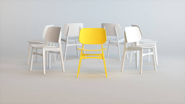 istock 3D Yellow Chair Standing Out Among White Chairs in Minimal Studio 2250781199
