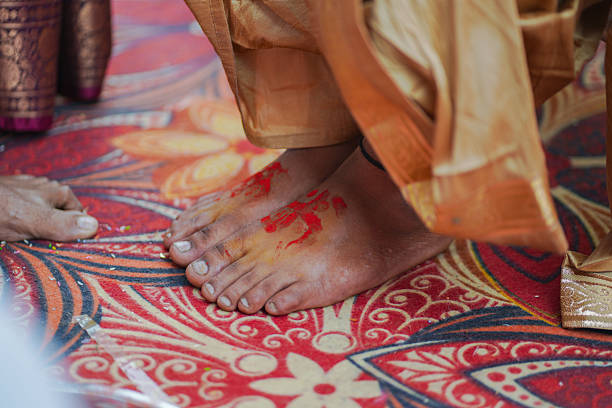 Close-up image of auspicious red-colored footprints made during a Hindu wedding ritual, showing the groom’s feet adorned with sindoor markings as part of traditional Marathi marriage customs.
