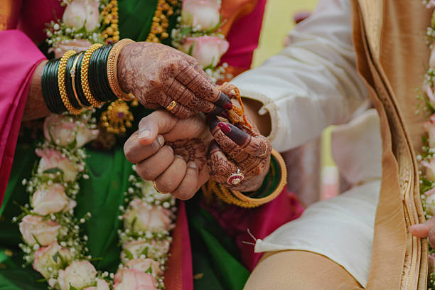 istock Traditional Indian bride and groom holding hands during wedding ritual 2250781274
