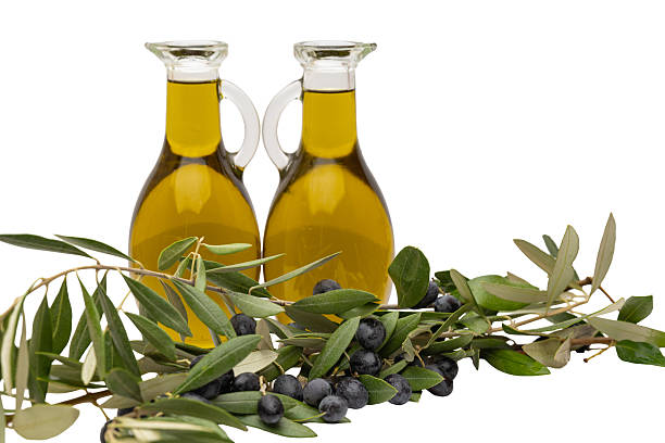 Natural soap bar, oil, olives and leaves isolated on white