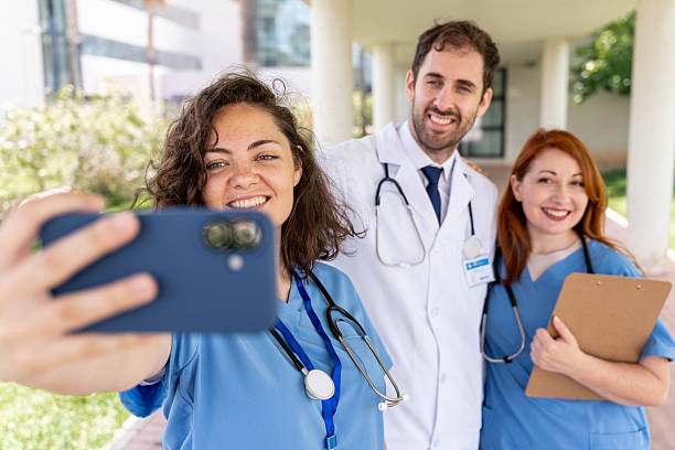 istock Diverse group of doctors and nurses taking a selfie with a smartphone, celebrating teamwork and modern healthcare 2250785563