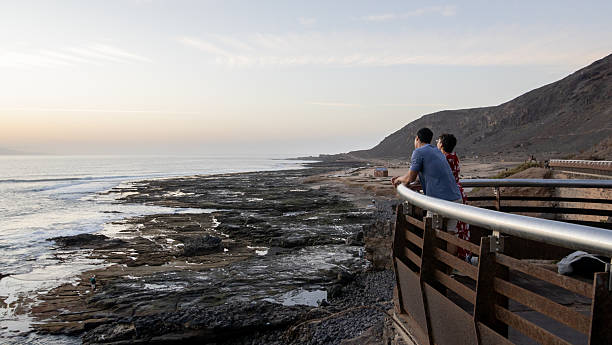 istock Couple looking at the sea from a viewpoint 2250789054
