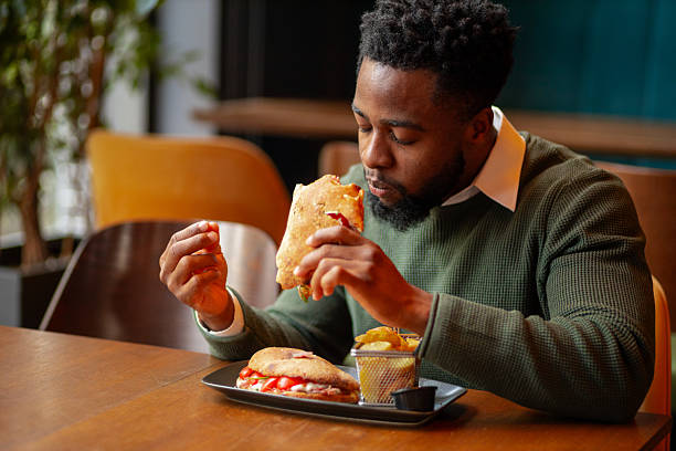 istock Young Black man enjoying lunch break in restaurant 2250789624