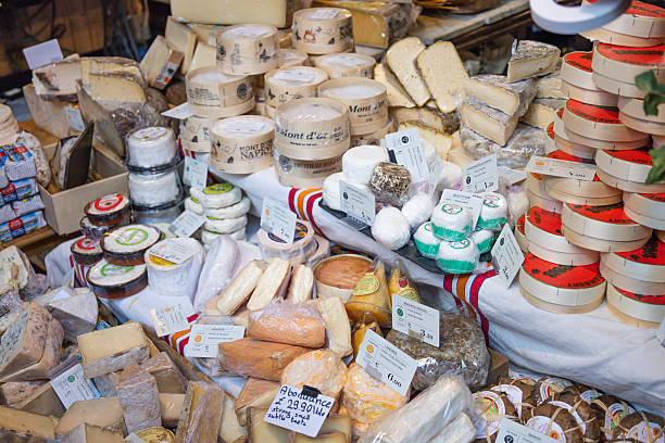 A variety of artisanal cheeses on display at a stall in Borough Market. London, UK, 17 December 2023