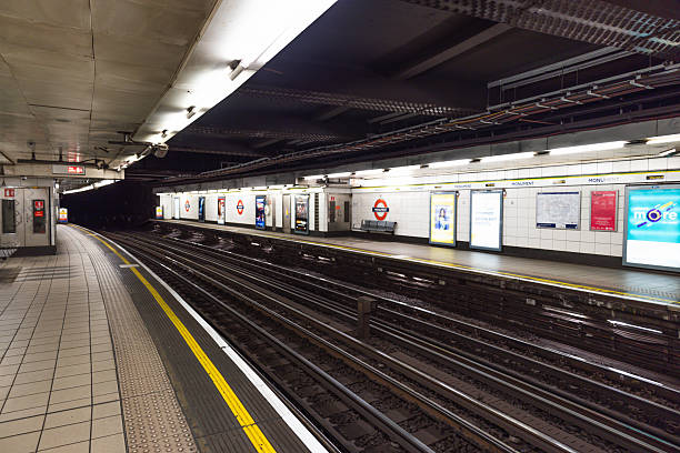 Defocused view of a London Tube station interior, ideal for use as a transport background, showing the platform and subway tracks without people. London, UK, 10 December 2023