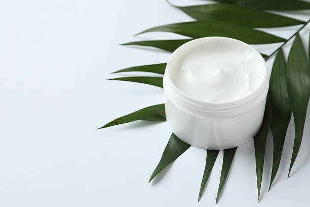 istock Jar of body cream with palm leaf on a white background 2250792316