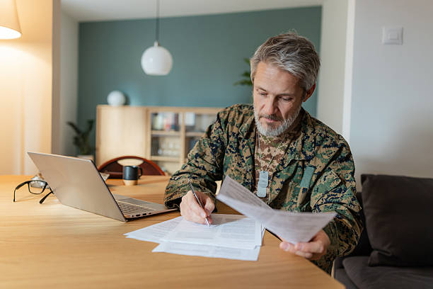 istock Military veteran reviewing paperwork in a home office setting 2250798708