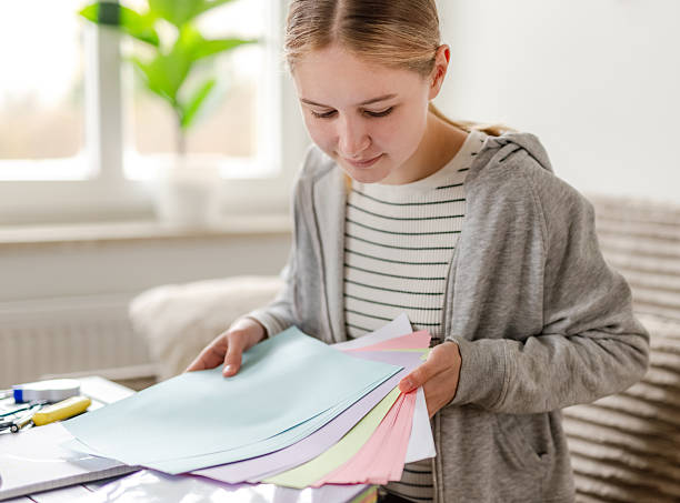 istock Girl Is Choosing Colored Paper 2250800194