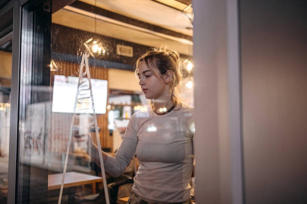 istock Artist creating Christmas decoration on cafe window 2250812165