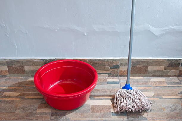 istock Red Bucket with Mop Indoors on Tile Floor for Cleaning 2250814688