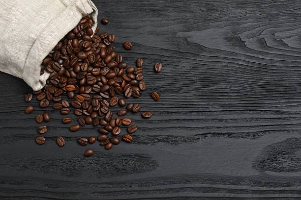 istock Coffee beans on wooden background 2250815444