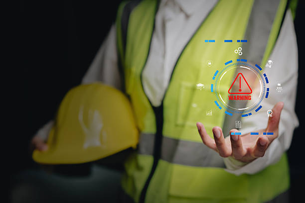 istock Warning alert concept, worker holding safety gear with digital caution icon overlay, operational risk awareness, safety monitoring, incident prevention workflow, workplace protection responsibility. 2250816400