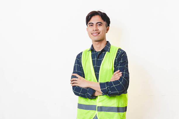 istock Confident construction worker standing with arms crossed against a clean background, showing professionalism, reliability, and readiness for work. 2250817475