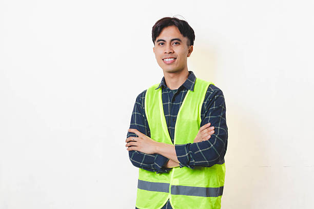 istock Confident construction worker standing with arms crossed against a clean background, showing professionalism, reliability, and readiness for work. 2250817484