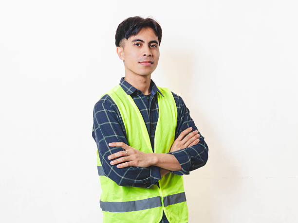 istock Confident construction worker standing with arms crossed against a clean background, showing professionalism, reliability, and readiness for work. 2250817485
