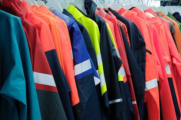 istock Multi-colored industrial protective clothing for work in extreme, harmful, aggressive conditions hangs on hangers on a stand. 2250820316